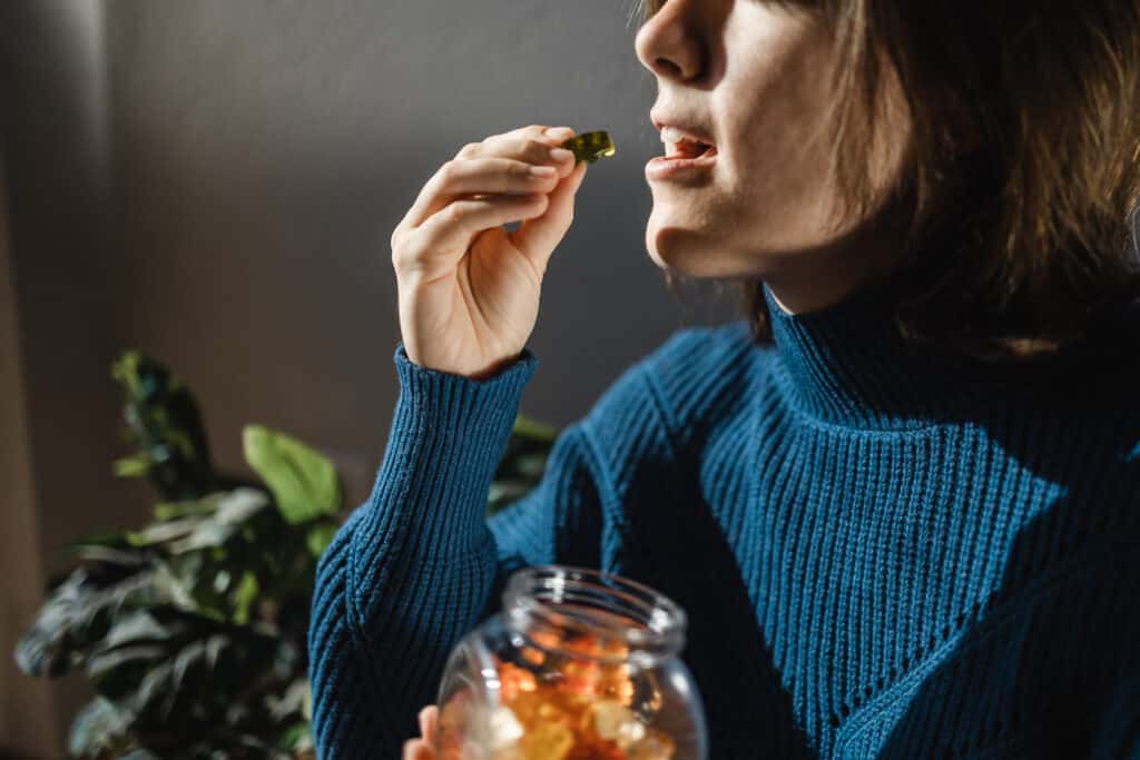 Woman eating delta 9 gummies